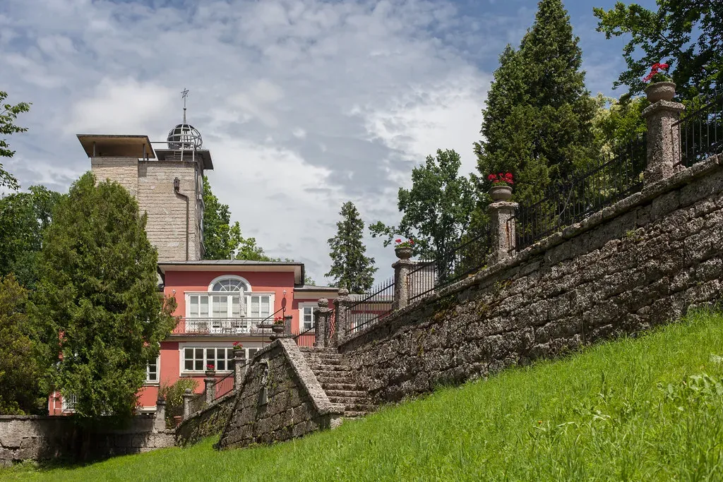 Large house with a lightning rod on its roof