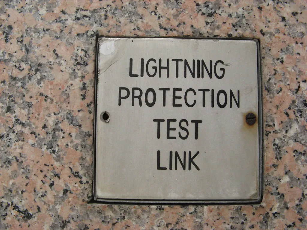 Metal plate marked Lightning Protection Test Link set into a stone wall