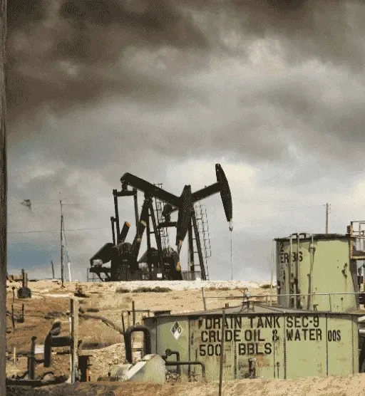 Pumpjack and crude oil tank at an oil and gas lease