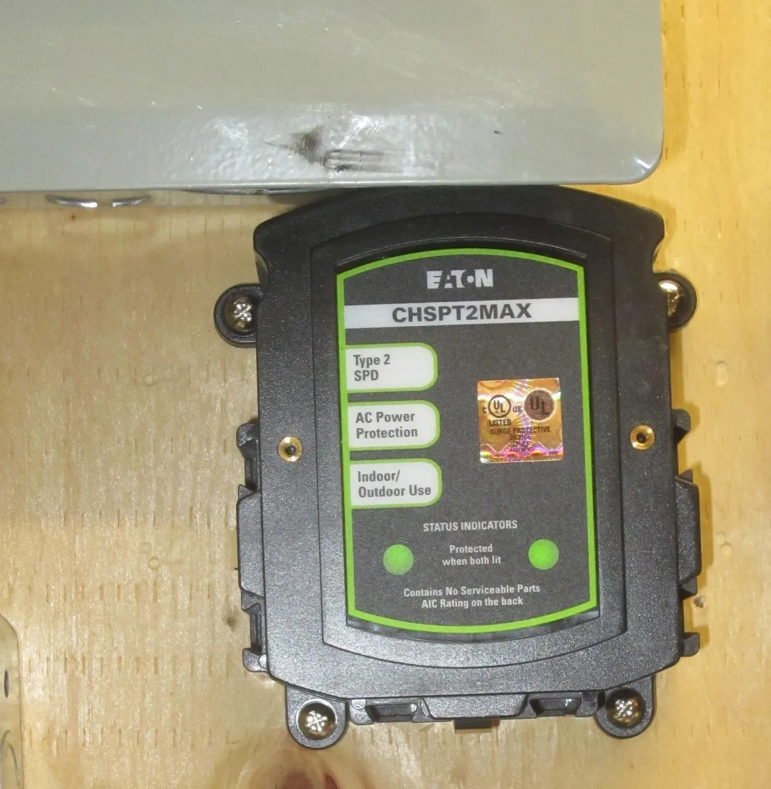 Whole-house surge protective device mounted on a wall